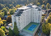Thumbnail 2 of 47 - a building with a tennis court on the bottom of it