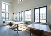 Thumbnail 16 of 27 - a tasting room with tables and chairs and large windows at Sonder Fields in Happy Valley, OR