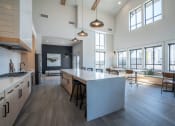 Thumbnail 15 of 27 - a large kitchen with a large island in the center of it at Sonder Fields in Happy Valley, OR