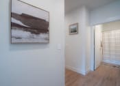 Thumbnail 8 of 27 - a painting hanging on a wall in a room with a door to a hallway at Sonder Fields in Happy Valley, OR