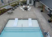 Thumbnail 24 of 27 - a swimming pool with chairs and tables around it at Sonder Fields in Happy Valley, OR