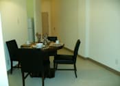 Thumbnail 14 of 17 - A dining table with four chairs around it.