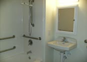 Thumbnail 17 of 17 - A white sink is on a white pedestal in a white bathroom.