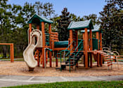 Thumbnail 97 of 115 - A playground with a green roof and a slide.
