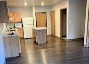 Thumbnail 109 of 115 - A kitchen with a refrigerator, microwave, and oven.