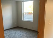 Thumbnail 111 of 115 - A room with a carpeted floor and a window.