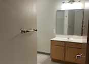 Thumbnail 114 of 115 - A bathroom with a sink, mirror, and medicine cabinet.
