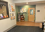 Thumbnail 102 of 115 - A room with a carpeted floor and a bookshelf.