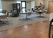 Thumbnail 101 of 115 - A room with a wooden floor and a table with chairs.