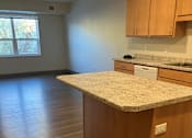 Thumbnail 110 of 115 - A kitchen with wooden cabinets and a granite countertop.