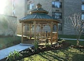 Thumbnail 4 of 17 - A gazebo is surrounded by a small garden and a pool.