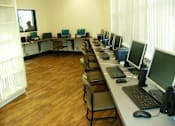 Thumbnail 10 of 17 - A room with a long table and chairs with multiple monitors on the table.