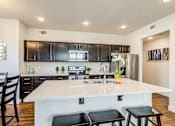 Thumbnail 4 of 26 - kitchen showcasing the quartz island and undermount sink at Bucking Horse Apartments, Fort Collins, CO, 80525