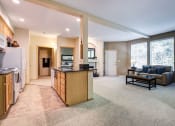 Thumbnail 7 of 30 - a living room with a kitchen and a couch at Madison Sierra Sun, Puyallup, Washington
