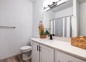 Thumbnail 14 of 30 - a bathroom with a toilet and a large mirror at Madison Sierra Sun, Puyallup, Washington