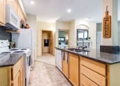 Thumbnail 8 of 30 - a kitchen with a counter top and a sink at Madison Sierra Sun, Puyallup, 98374