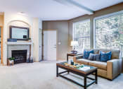 Thumbnail 9 of 30 - a living room with a couch and a fireplace at Madison Sierra Sun, Puyallup, Washington