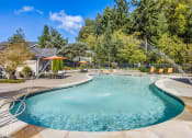 Thumbnail 4 of 30 - a resort style swimming pool with water sprinklers     and a patio at Madison Sierra Sun, Puyallup, 98374