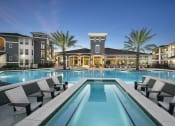Thumbnail 1 of 33 - Pool surrounded by clubhouse and buildings at The Parkway on Westlake, Humble, 77346