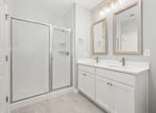 Thumbnail 107 of 124 - A white bathroom with a walk-in shower and double sink vanity at Madison Prickett Preserve, Pennsylvania