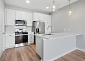 Thumbnail 91 of 124 - A modern kitchen with white cabinets and stainless steel appliances at Madison Prickett Preserve, Yardley