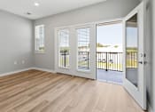 Thumbnail 101 of 124 - A room with a sliding glass door leading to a balcony at Madison Prickett Preserve, Yardley, PA