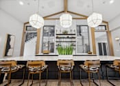 Thumbnail 4 of 124 - A modern dining area with a long table and chairs at Madison Prickett Preserve, Yardley