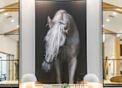 Thumbnail 17 of 124 - A large black and white photograph of a horse is displayed on a wall above a wooden table at Madison Prickett Preserve, Yardley, 19067