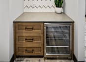 Thumbnail 41 of 124 - a kitchen with a counter top and a glass refrigerator at Madison Prickett Preserve, Yardley, 19067