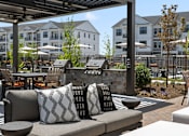 Thumbnail 51 of 124 - a patio with couches and tables and a pergola at Madison Prickett Preserve, Yardley Pennsylvania