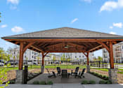 Thumbnail 62 of 124 - a pavilion with a table and chairs under it at Madison Prickett Preserve, Yardley