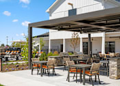 Thumbnail 50 of 124 - A patio with a table and chairs is shaded by a large awning at Madison Prickett Preserve, Yardley
