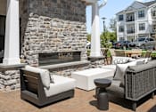 Thumbnail 56 of 124 - a rendering of a patio with couches and a fireplace at Madison Prickett Preserve, Yardley