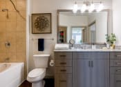 Thumbnail 17 of 33 - a bathroom with a sink toilet and a mirror at The Parkway on Westlake, Texas, 77346