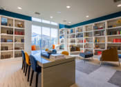 Thumbnail 20 of 33 - a library with bookshelves and a table and chairs  at The Parkway on Westlake, Humble, 77346