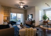Thumbnail 9 of 33 - a living room with furniture and a ceiling fan at The Parkway on Westlake, Humble, TX