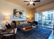 Thumbnail 8 of 33 - a living room with a couch and a sliding glass door at The Parkway on Westlake, Humble, 77346