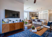 Thumbnail 7 of 33 - an open living room and kitchen with a large tv at The Parkway on Westlake, Humble, Texas