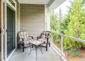 Thumbnail 12 of 30 - a patio with two chairs and a coffee table at Madison Sierra Sun, Washington
