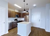 Thumbnail 5 of 18 - A kitchen with white cabinets and a white island.