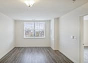 Thumbnail 24 of 30 - A large empty room with a window overlooking a cityscape.