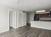 Thumbnail 22 of 33 - A room with a wooden floor and white walls.