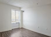 Thumbnail 12 of 16 - A room with wooden flooring and a window.