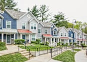 Thumbnail 3 of 18 - A row of houses with blue and grey exteriors.