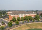Thumbnail 2 of 17 - a large brick building with trees in front of it