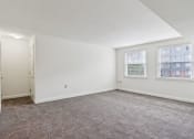 Thumbnail 9 of 17 - a living room with carpet and two windows