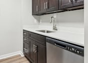 Thumbnail 6 of 15 - Modern, energy-efficient stainless steel appliances and sleek dark-tone cabinetry at Park Montgomery apartments located along the Purple Line in Silver Spring, MD.