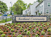 Thumbnail 13 of 18 - A sign that says Scotland Community in front of some houses.