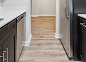 Thumbnail 7 of 15 - Sleek galley kitchens at Park Montgomery apartments located along the Purple Line in Silver Spring, MD.