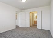 Thumbnail 19 of 26 - A room with white walls and a grey carpet.